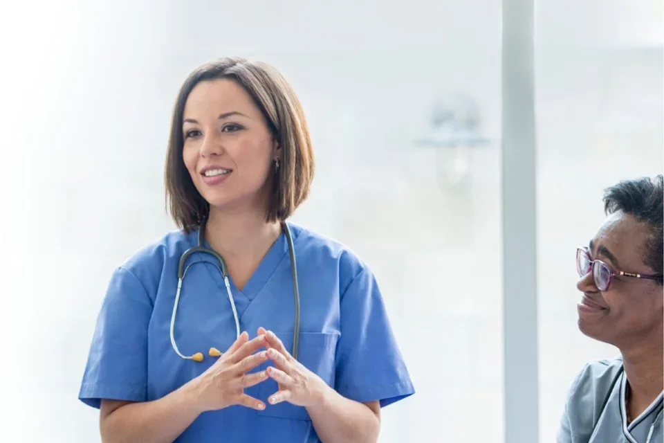 Doctor speaks with nurse looking on